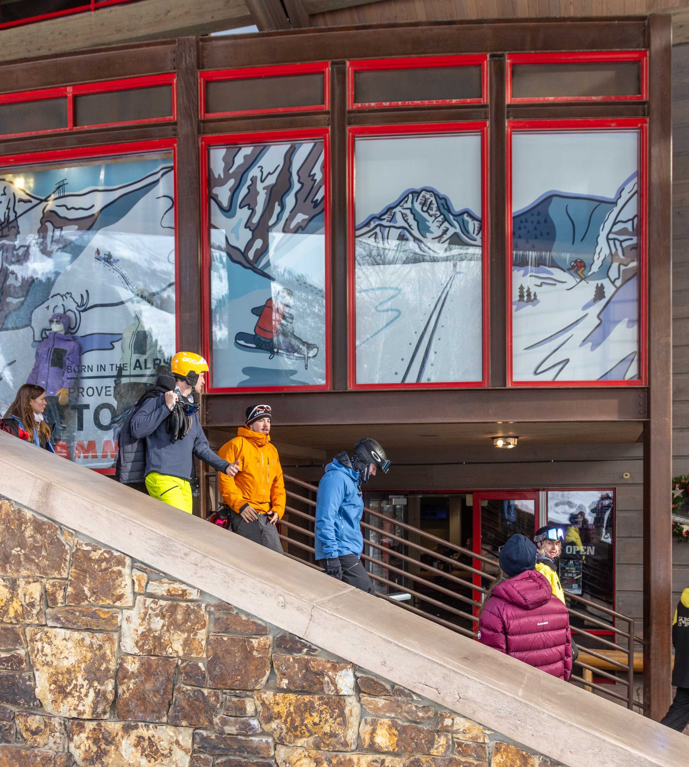 Guests walking by the window display at the base of Jackson Hole Mountain Resort, art by Kia Tolan.