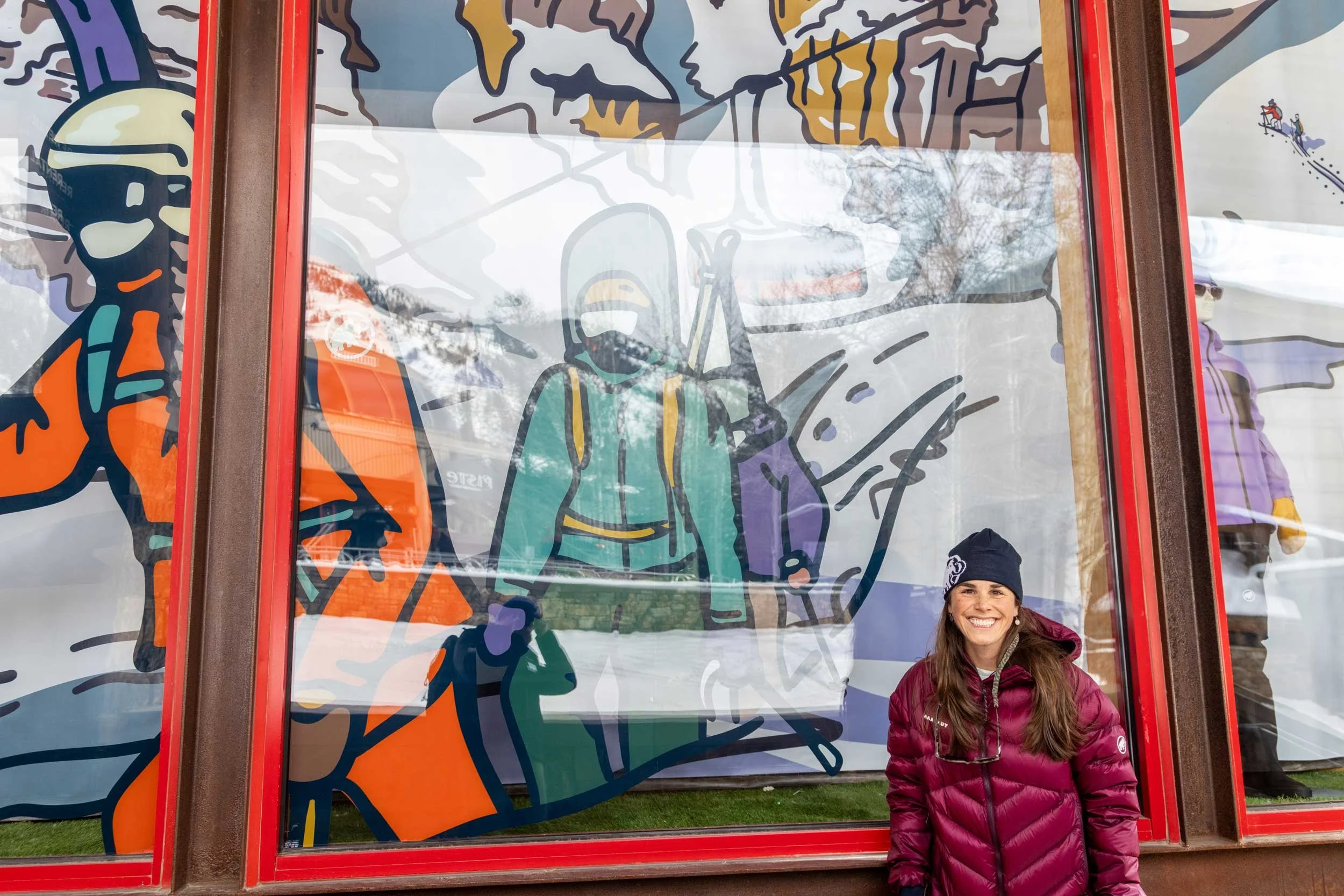 Kia Tolan in front of her winning window display design at Jackson Hole Mountain Resort.