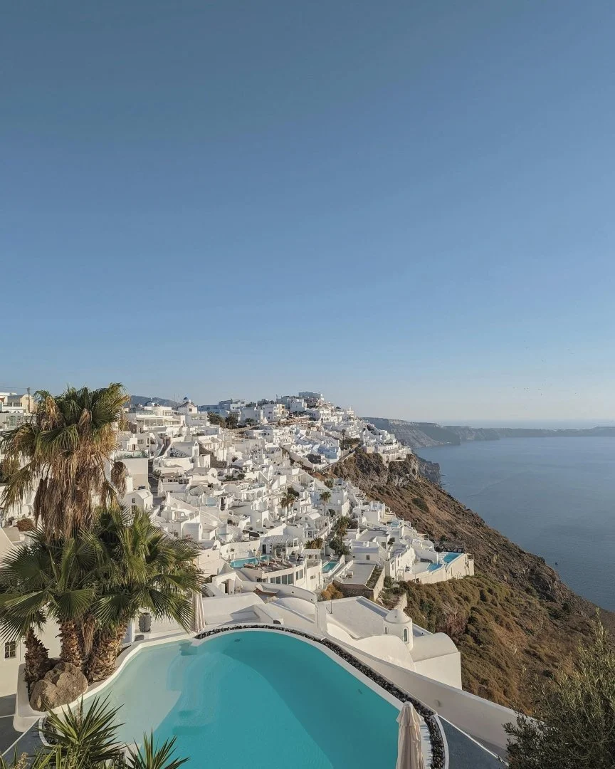 Couple enjoying the room from their hotel in Santorini on their Greek Honeymoon