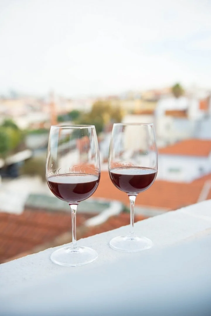 Couple enjoying wine on their balcony in Spain on their European Honeymoon