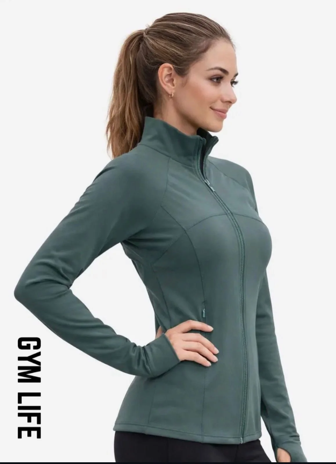 A woman with brown hair tied back, wearing a green athletic jacket with a high collar, shown in side profile.