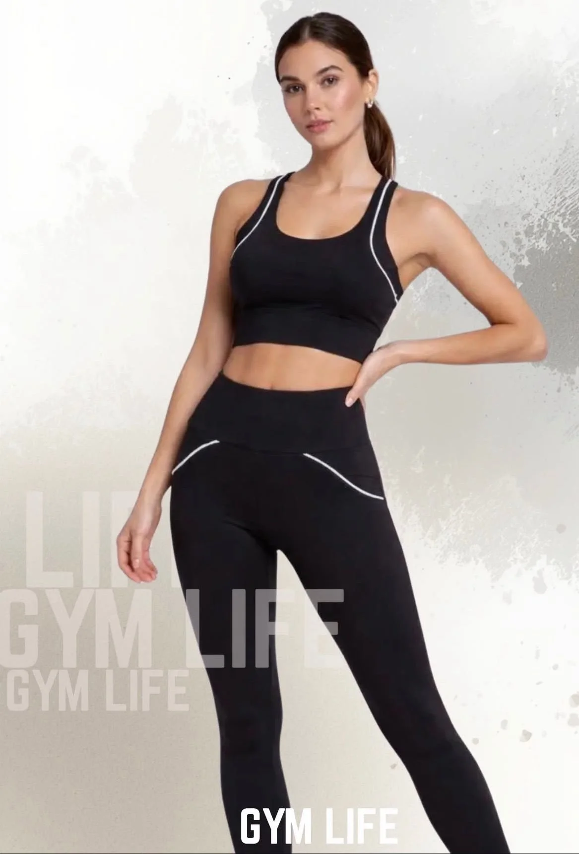 A woman in black athletic wear posing with her hand on her hip against a plain background with the words "GYM LIFE" in the corner.