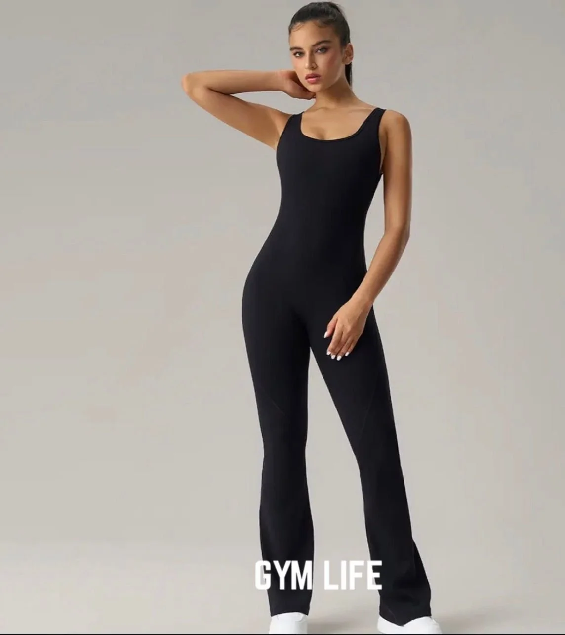 A young woman in a black sleeveless jumpsuit posing against a plain background, with the text "GYM LIFE" at the bottom.