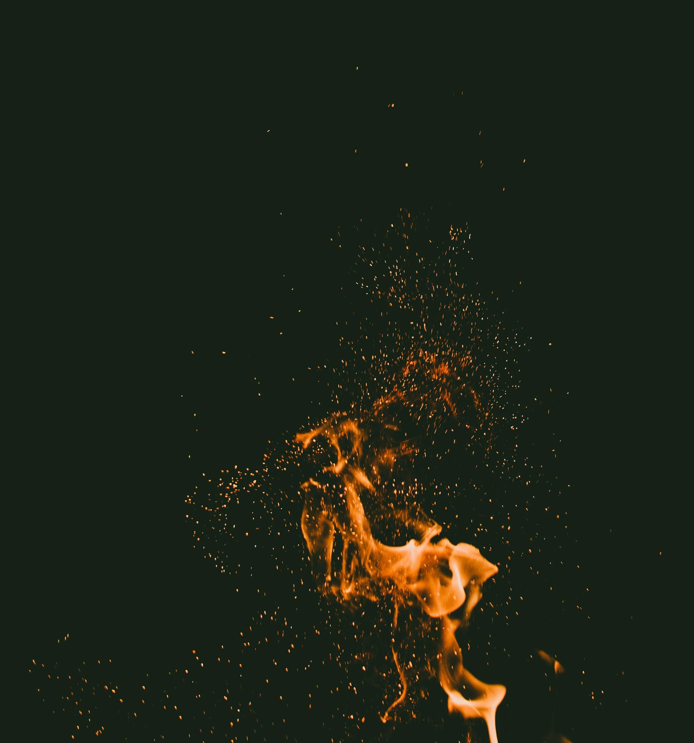 Fiery sparks and flames against a dark background.