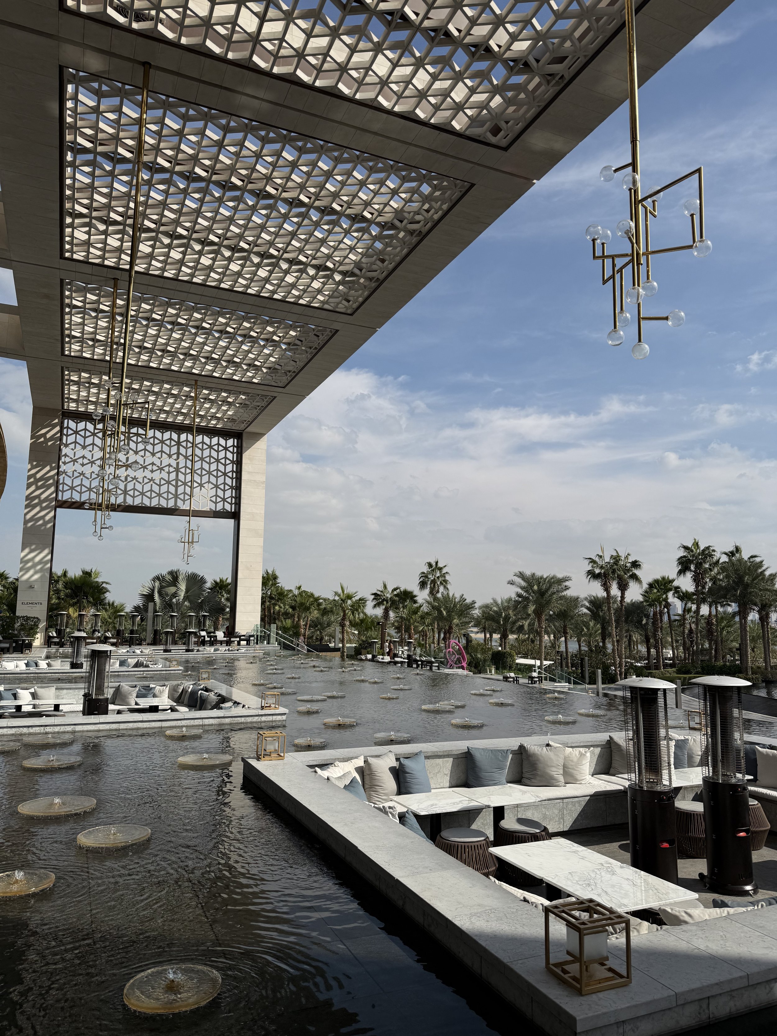 Atlantis The Royal, UAE — The imagery focuses on the 'deconstructed' silhouette of the architecture, where the voids between blocks frame the Arabian Gulf in a way that feels entirely new. This is luxury reimagined as a series of suspended gardens an
