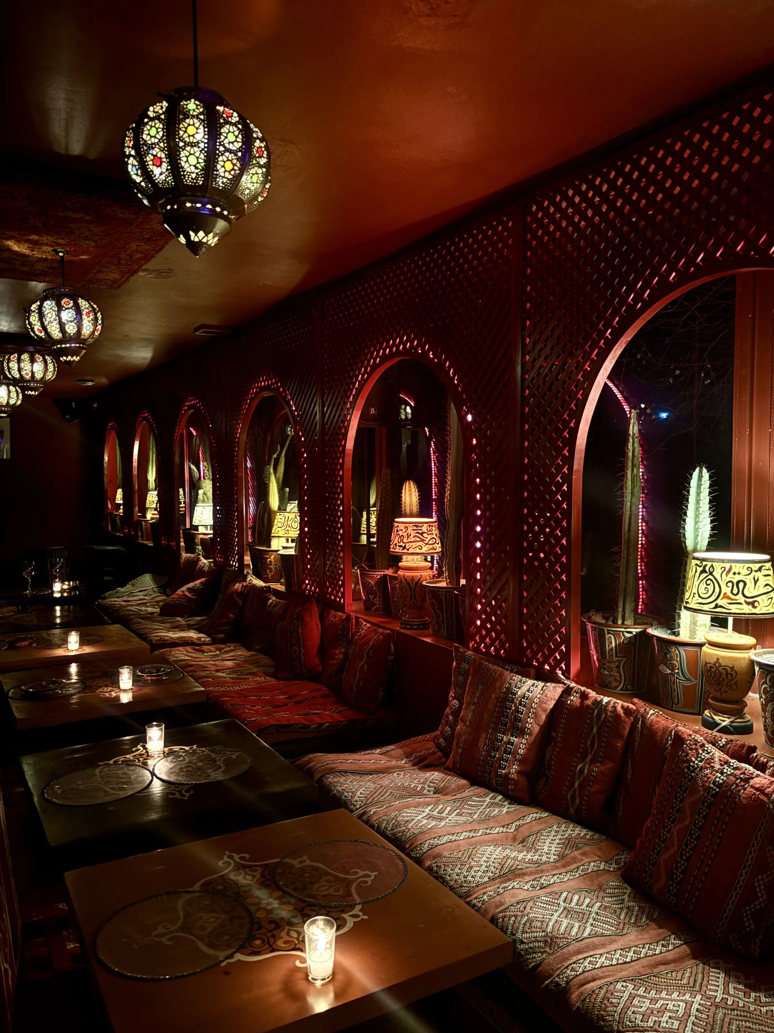 Marrakesh, Morocco — A masterclass in warmth, where the palette is drawn from the very earth of the Maghreb. The interior is a rhythmic play of burnt orange and deep cinnabar, illuminated by the amber glow of hand-pierced lanterns. To capture this sp