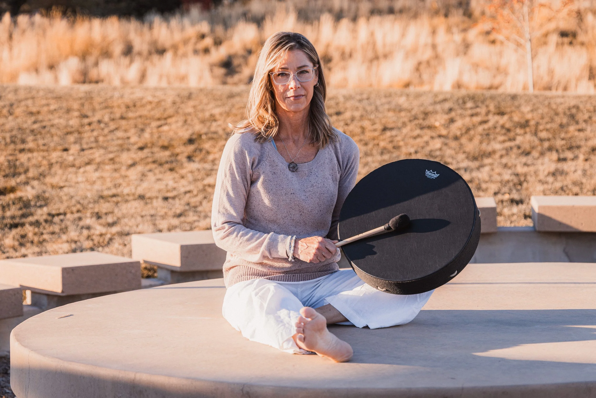 Women playing a sound healing drum