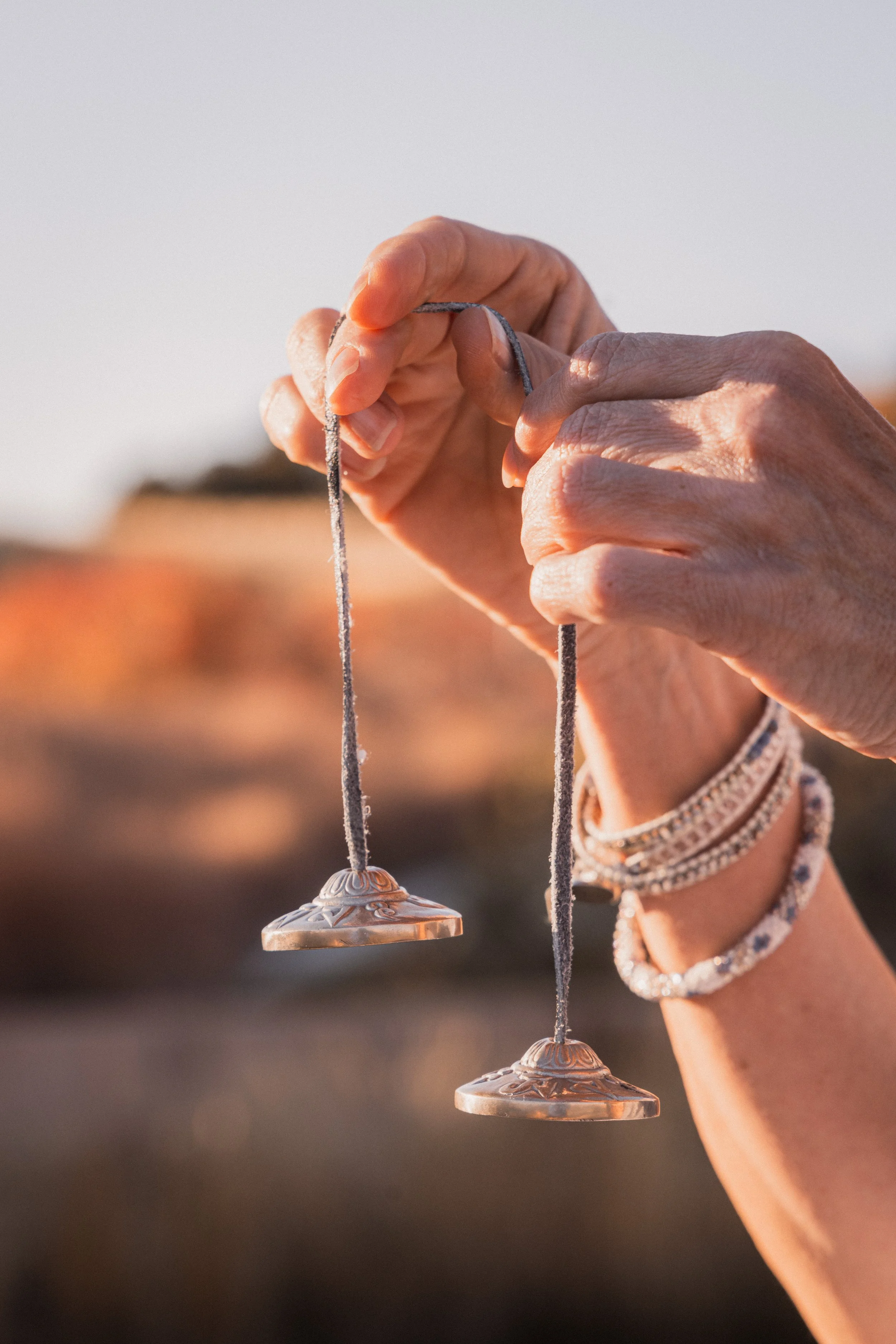 Sound healing chime held in the air by a women's hands