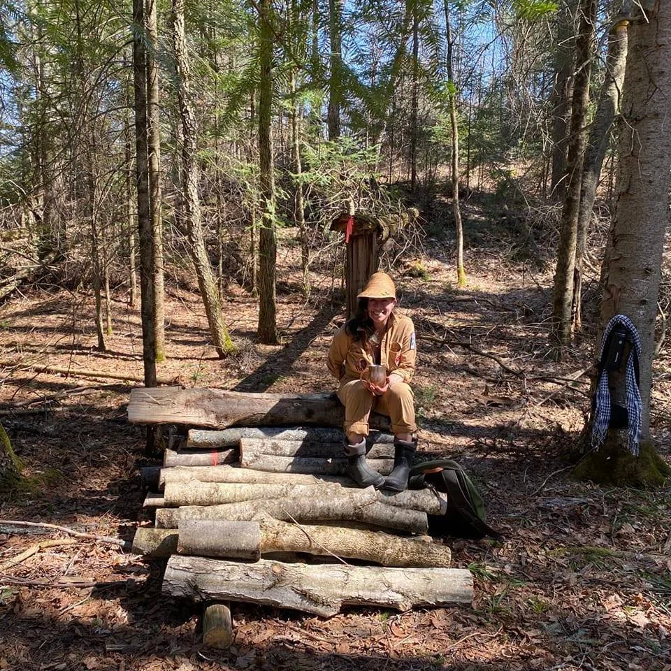 Slava sitting on freshly inoculated mycelium logs