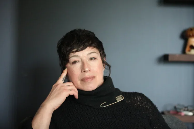 Slava, gestalt psychotherapist in Ontario, providing individual and couples therapy. Looking directly into the camera, she is listening attentively.