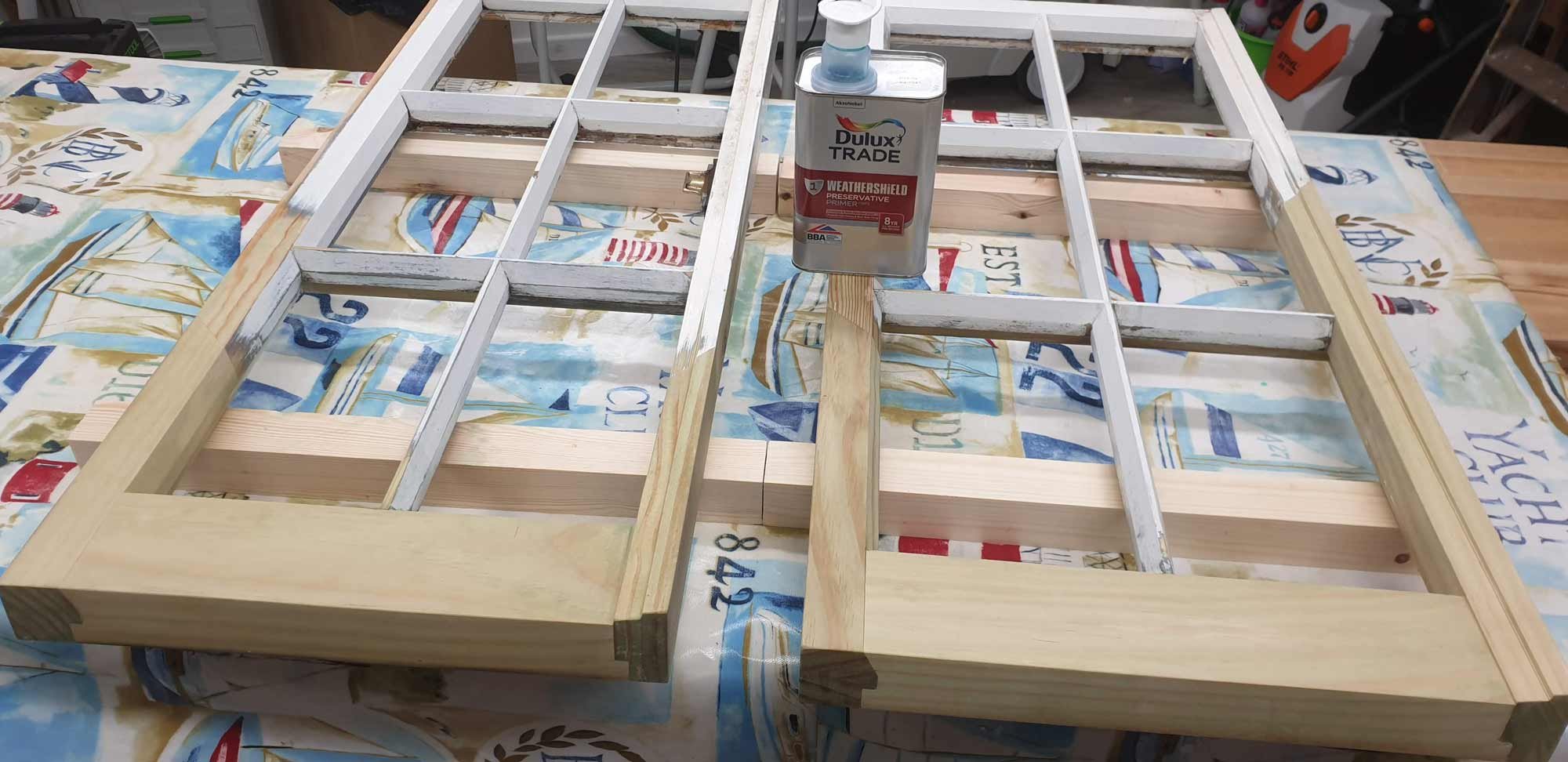 Glued and sanded sash window being treated