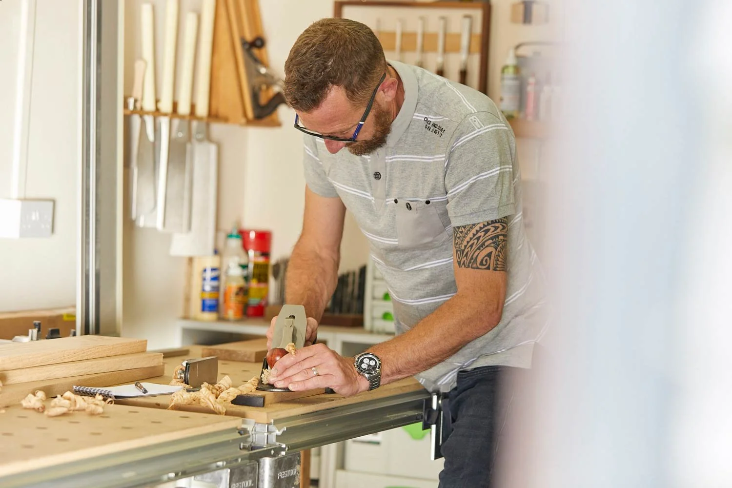 Richard Pearce planing wood in his workshop