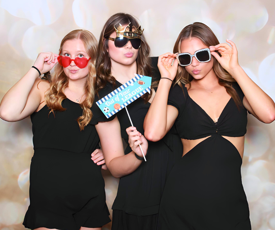 Teen guests posing with photo booth props at a Sweet 16 celebration in Valparaiso Indiana