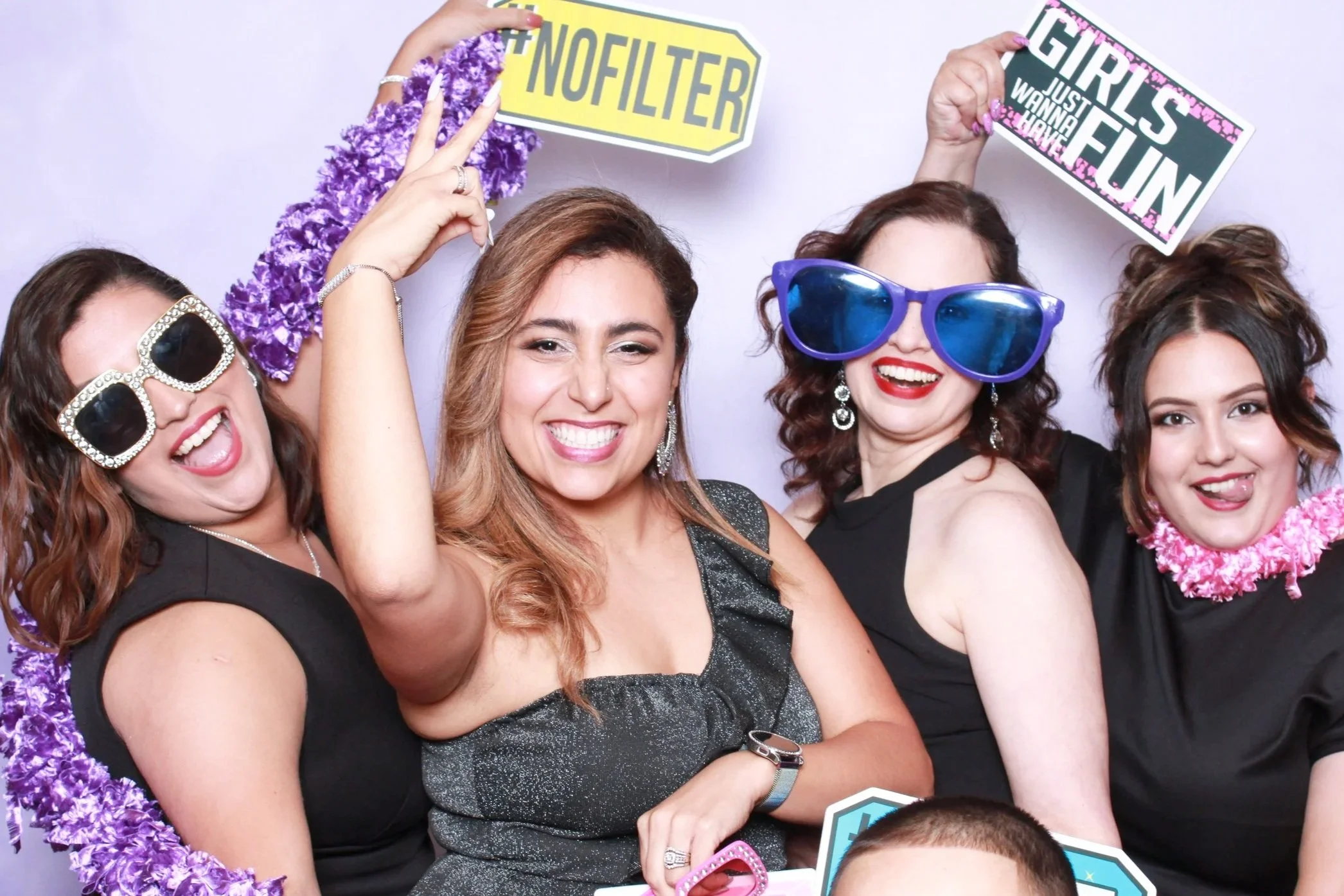 Guests having fun with props in a photo booth from Reflectionz Photo Booth Rentals in Northwest Indiana