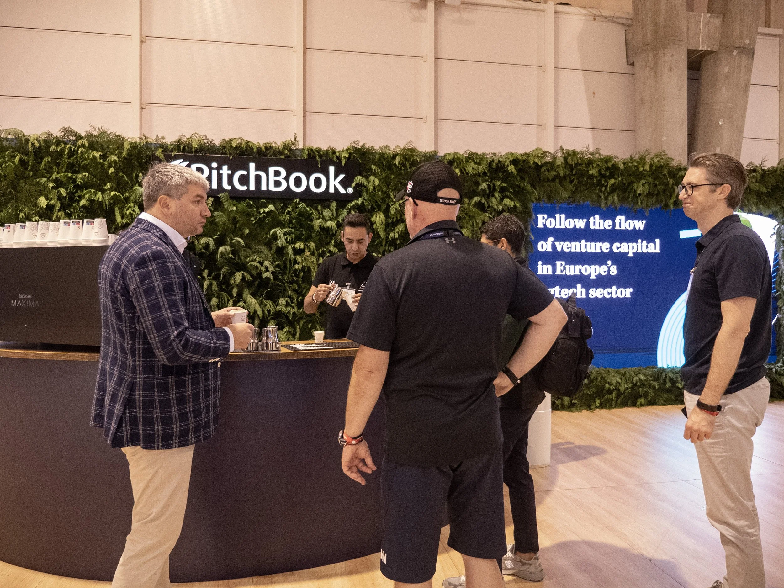 Coffee bar with green wall in background with an embedded television monitor with a looped video our team created