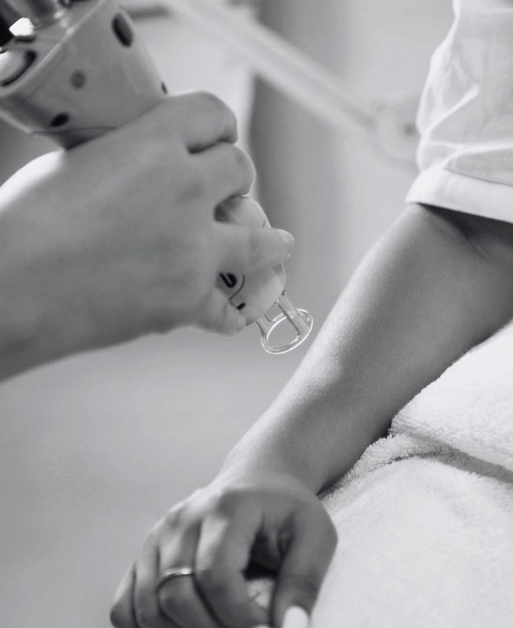 A healthcare professional administering a vaccine to a person's arm.