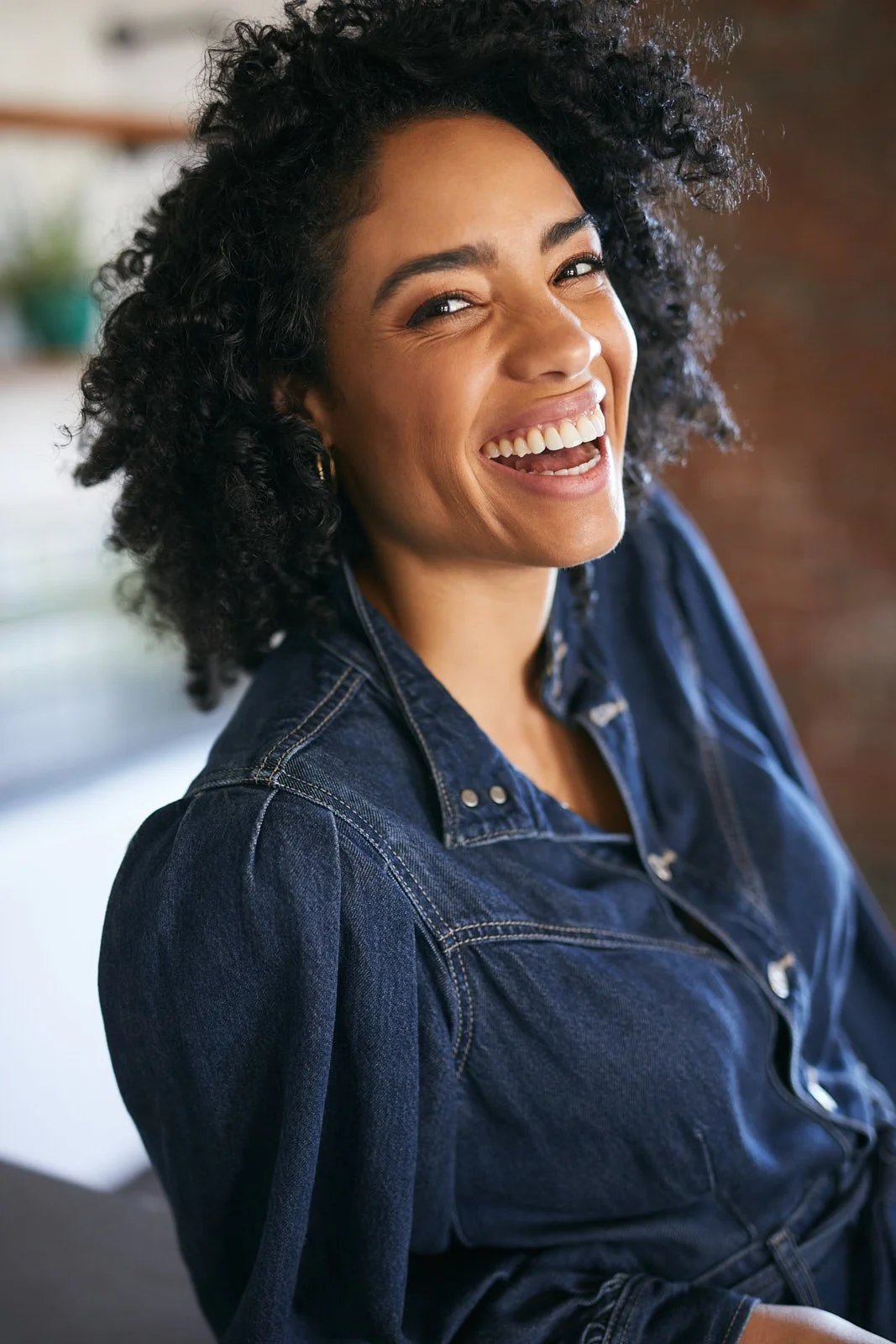 Model in denim jumper laughing at my dumb joke