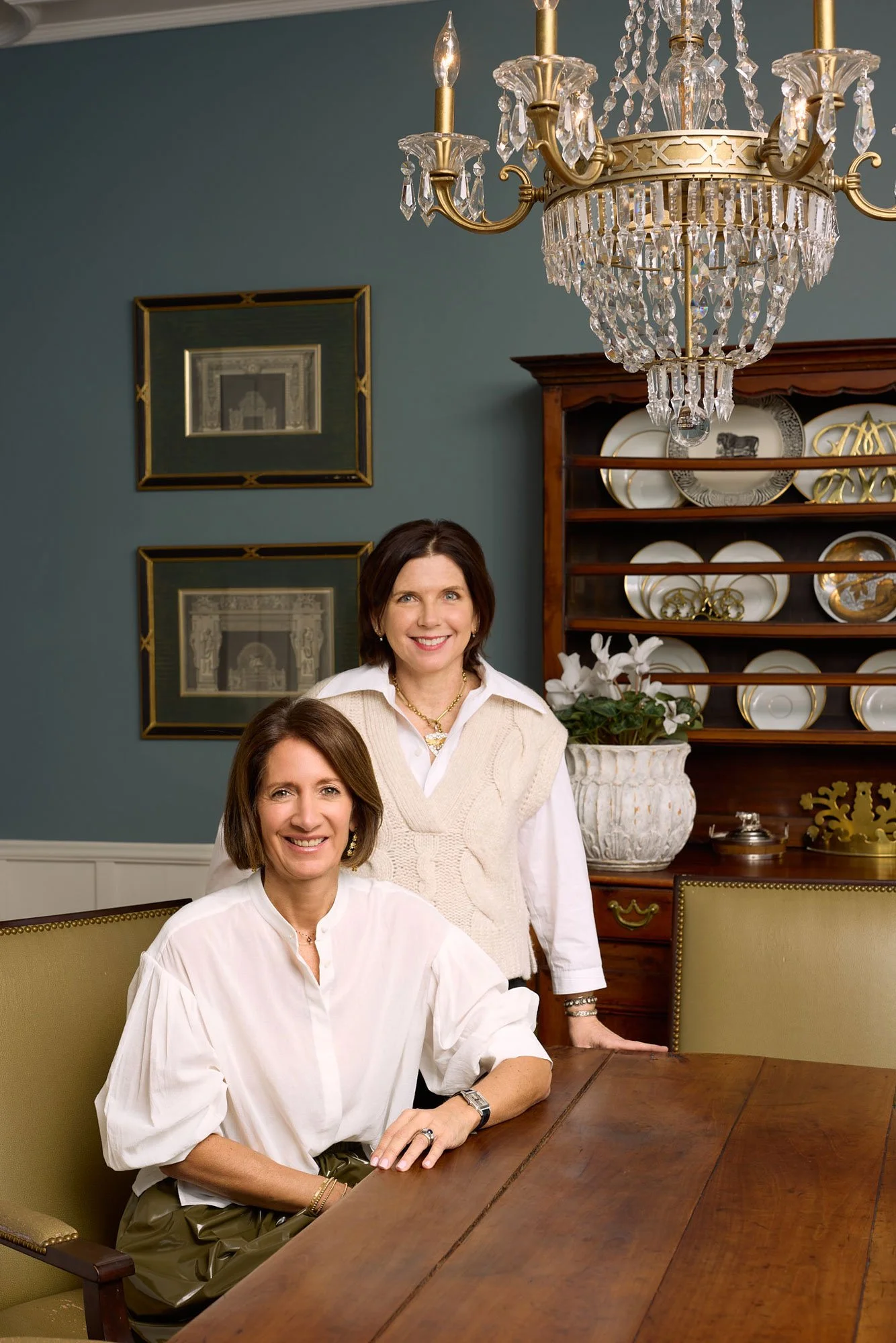 Two real estate agents posing in a elegant dining room in Denver Colorado