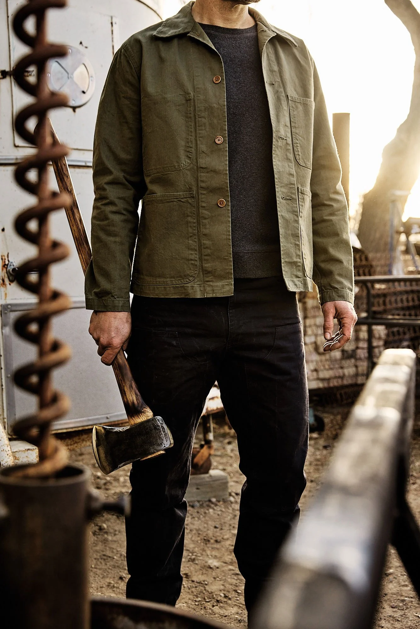 Workman holding axe wearing Best Made Co service jacket