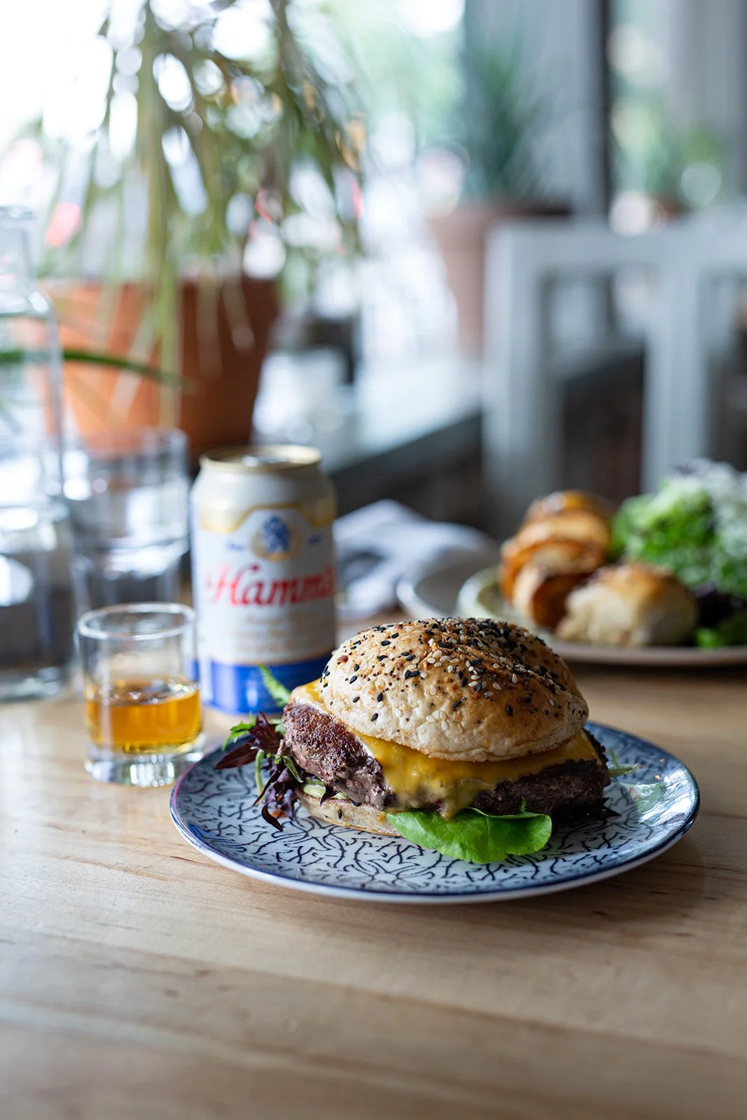Hamburger with a can of Hamms and shot of whiskey at The Regional restaurant in Fort Collins