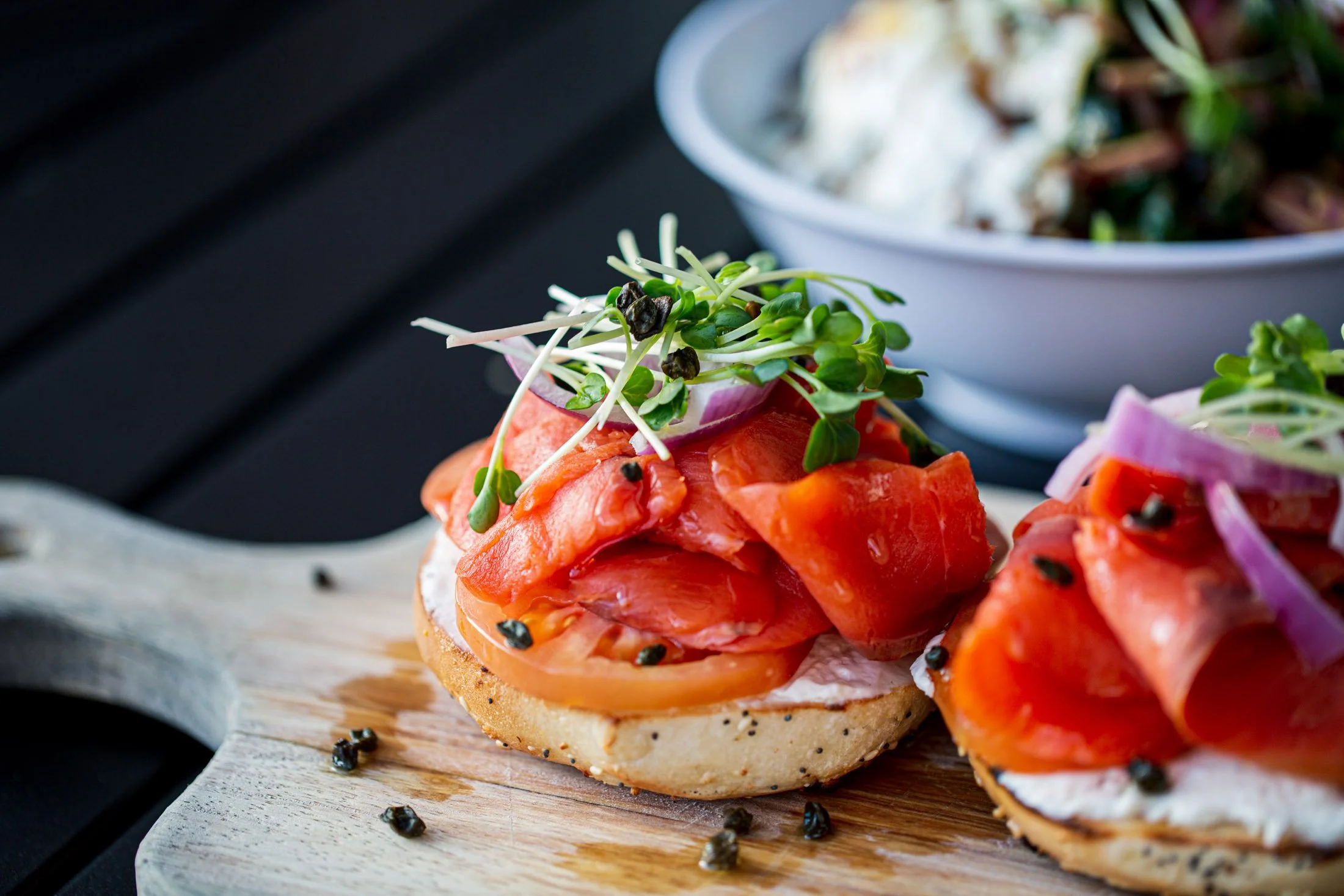 Smoked salmon bagels on a wooden serving board