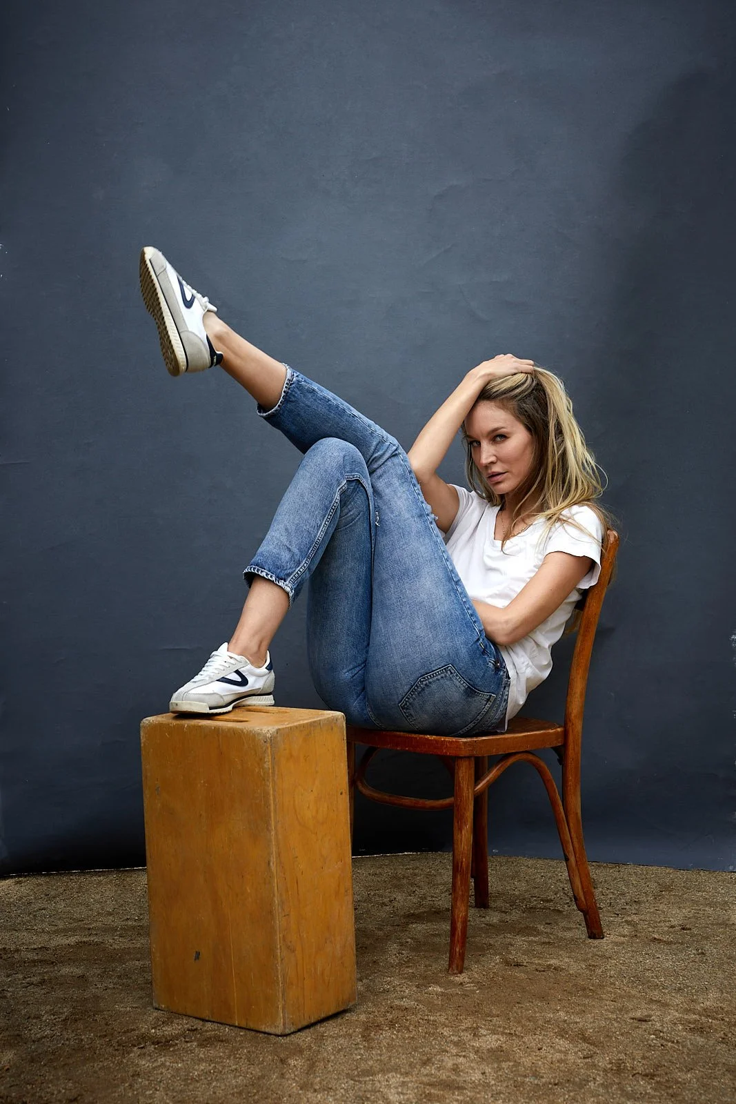 Model posing in front of an Oliphant backdrop