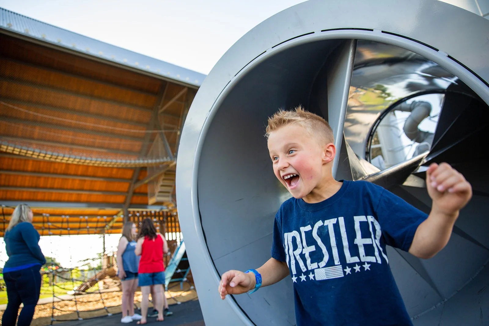 Young boy enjoying a playground slide