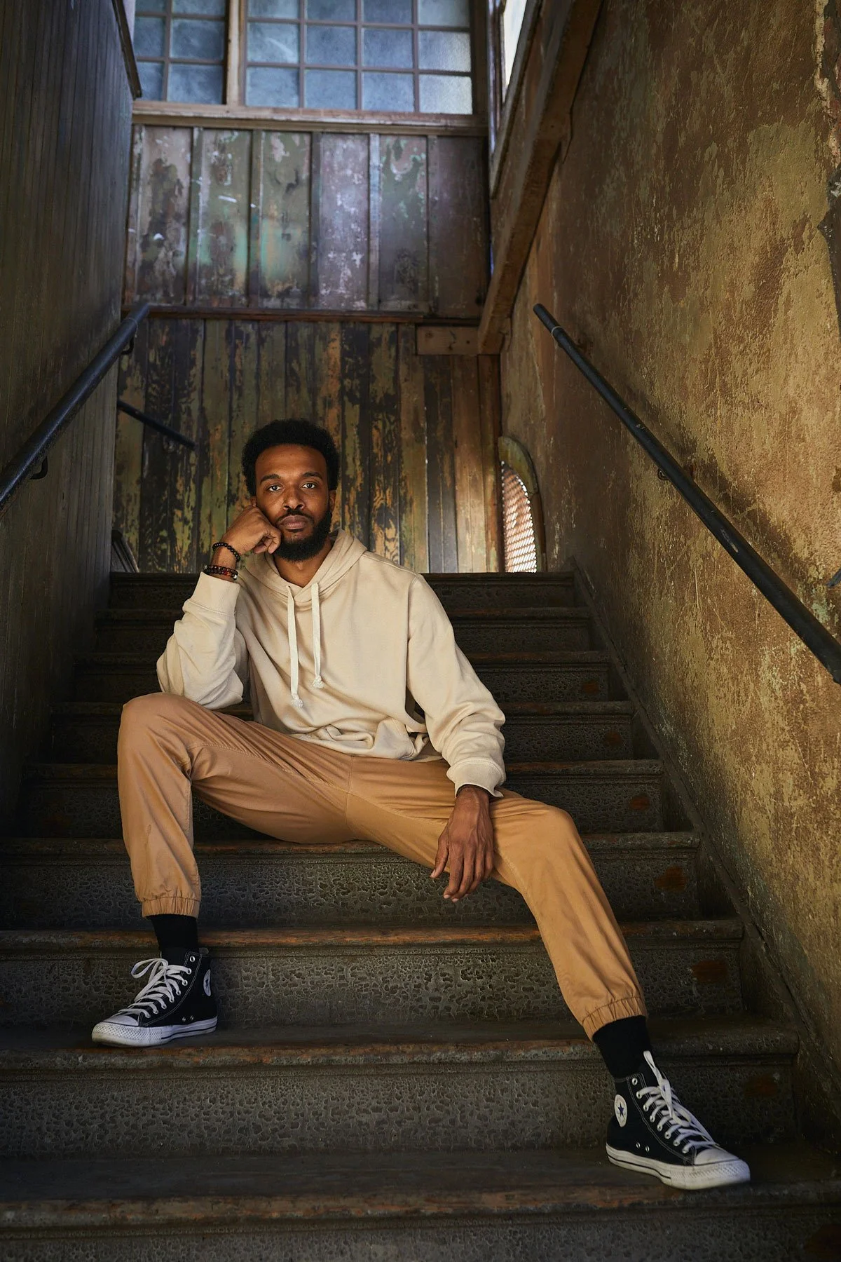 Model seated in a stairwell in the Nate Starkman building