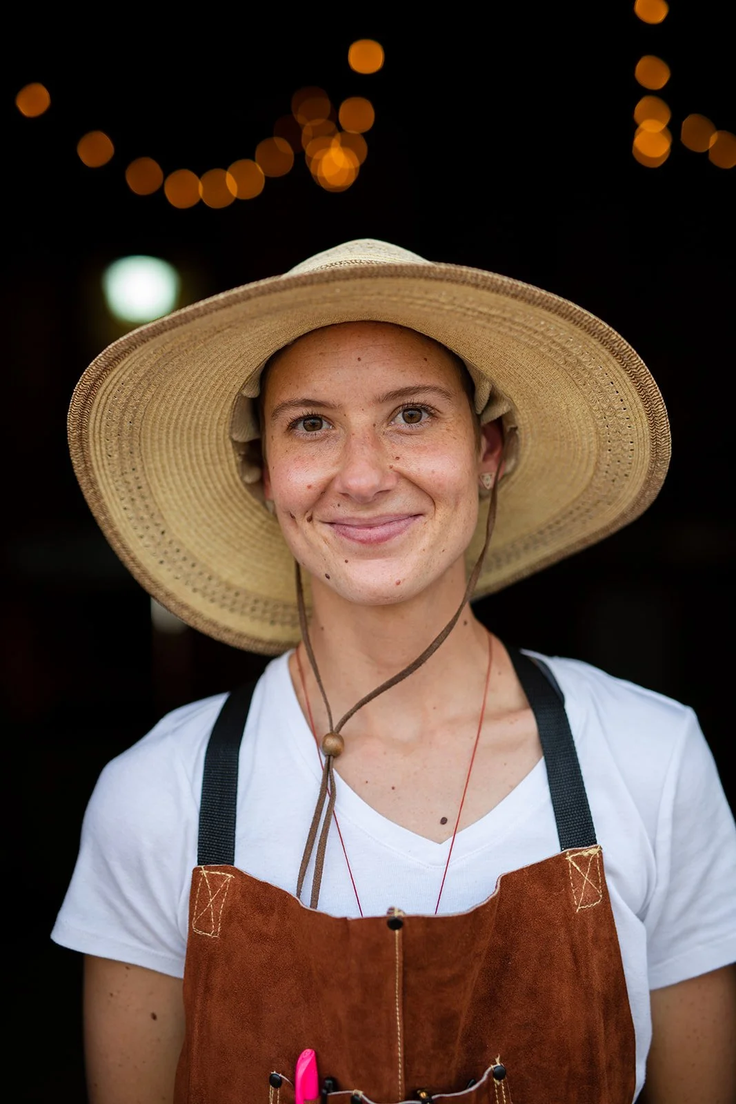 Chef wearing a large brim hat standing in an open barn doorway