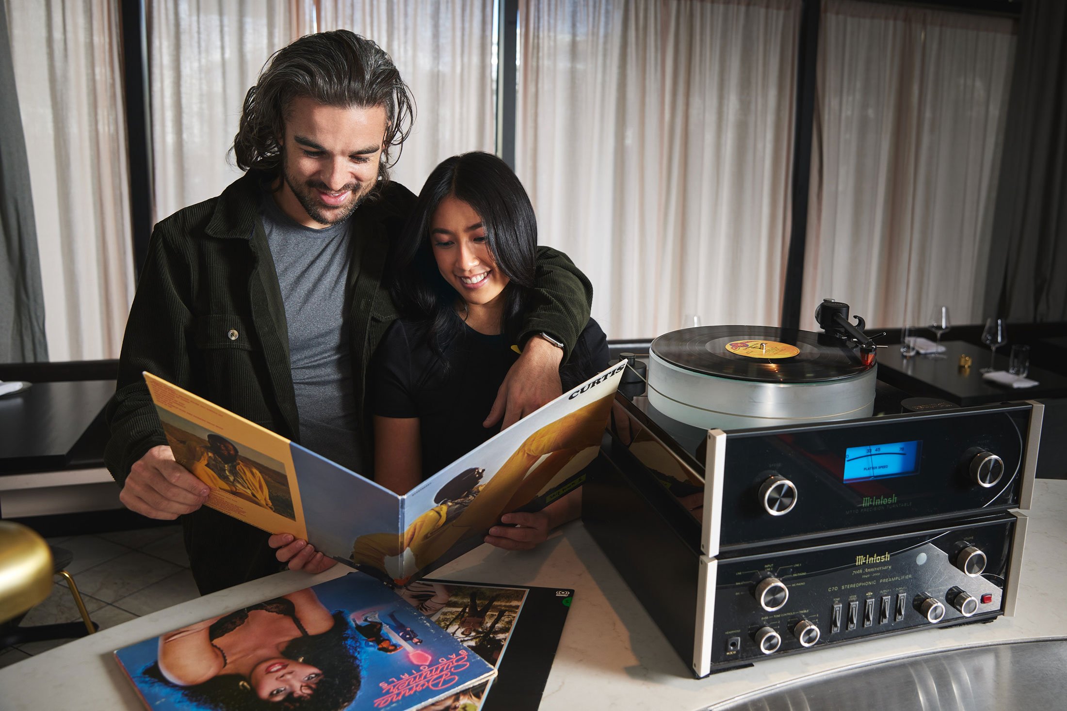 Couple looking at records at Sunday Vinyl restaurant in Denver Colorado