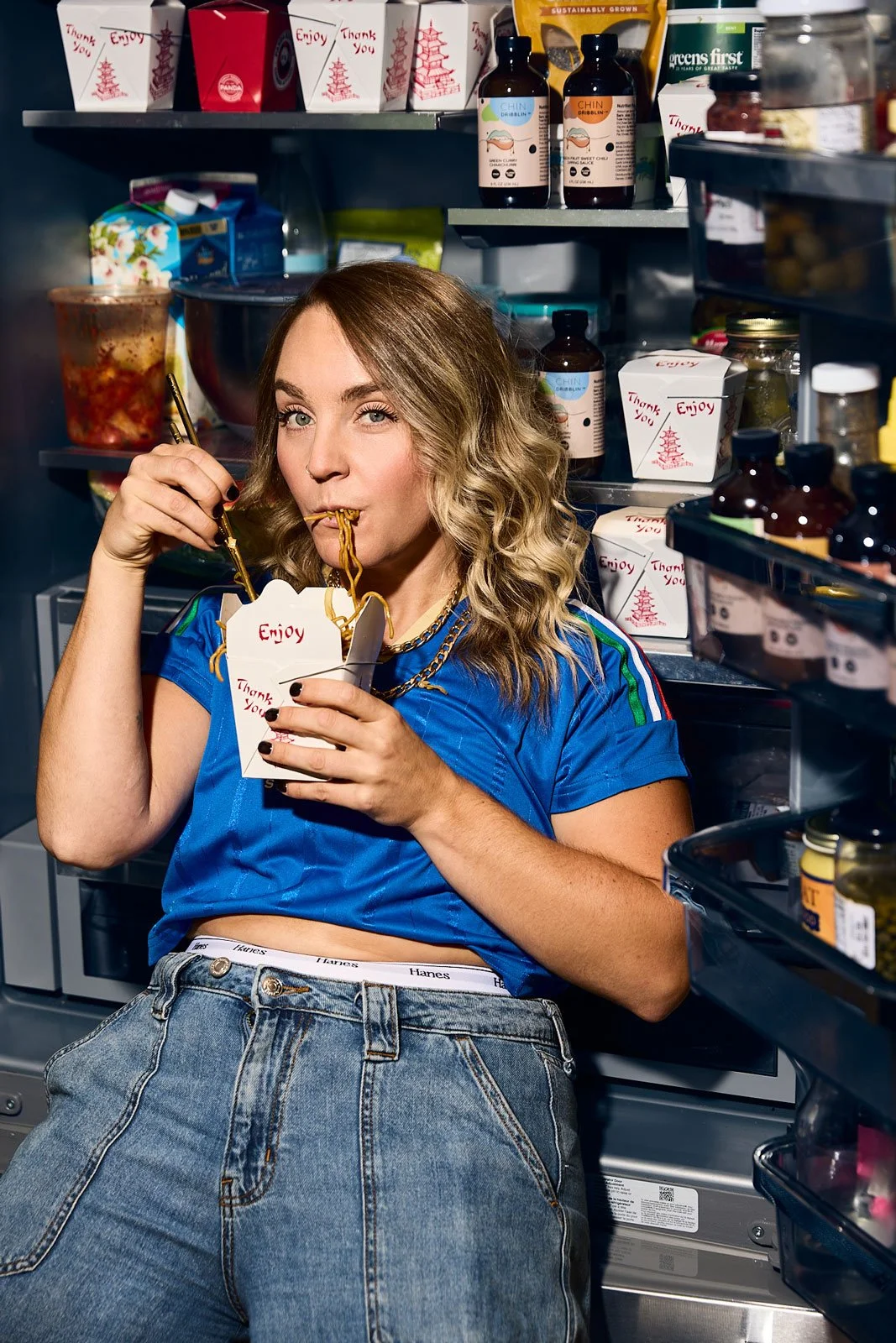 Chin Dribblin owner Ali Schlichter eating take out in a refrigerator
