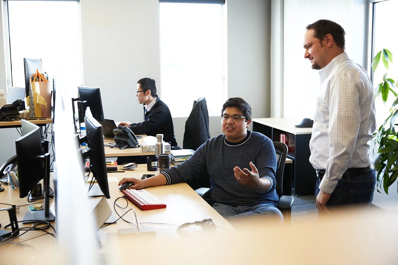 Engineers discussing a project at a computer