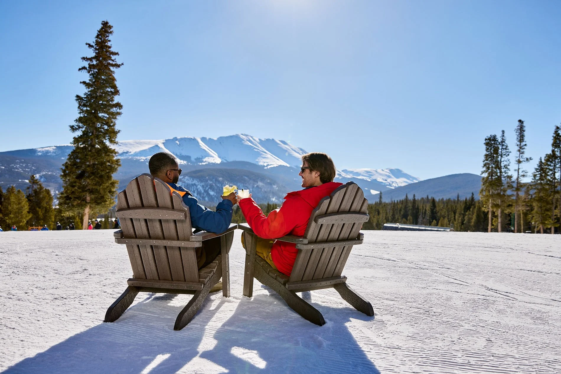Skiers sitting outside on chairs with drinks in Breckenridge Colorado