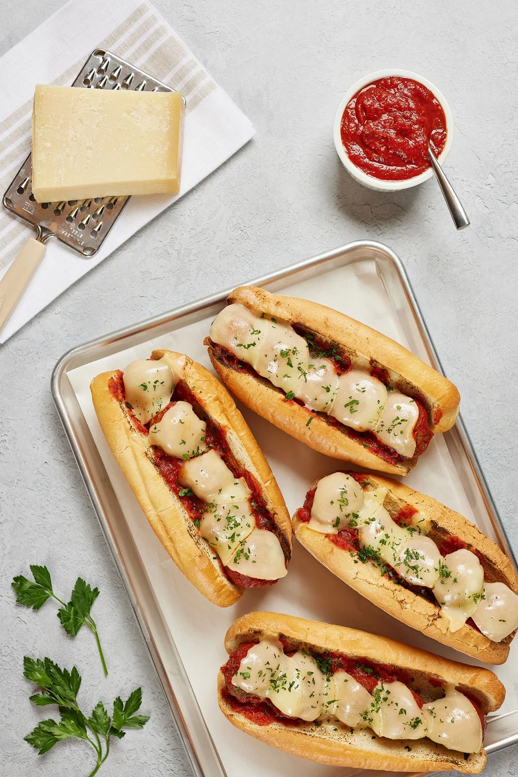 Top down view of four meatball parmesan sandwiches
