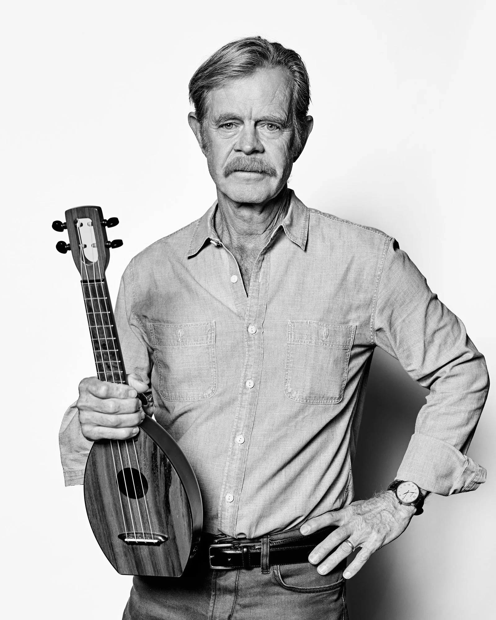 Black and white portrait of actor, William H. Macy with his ukulele