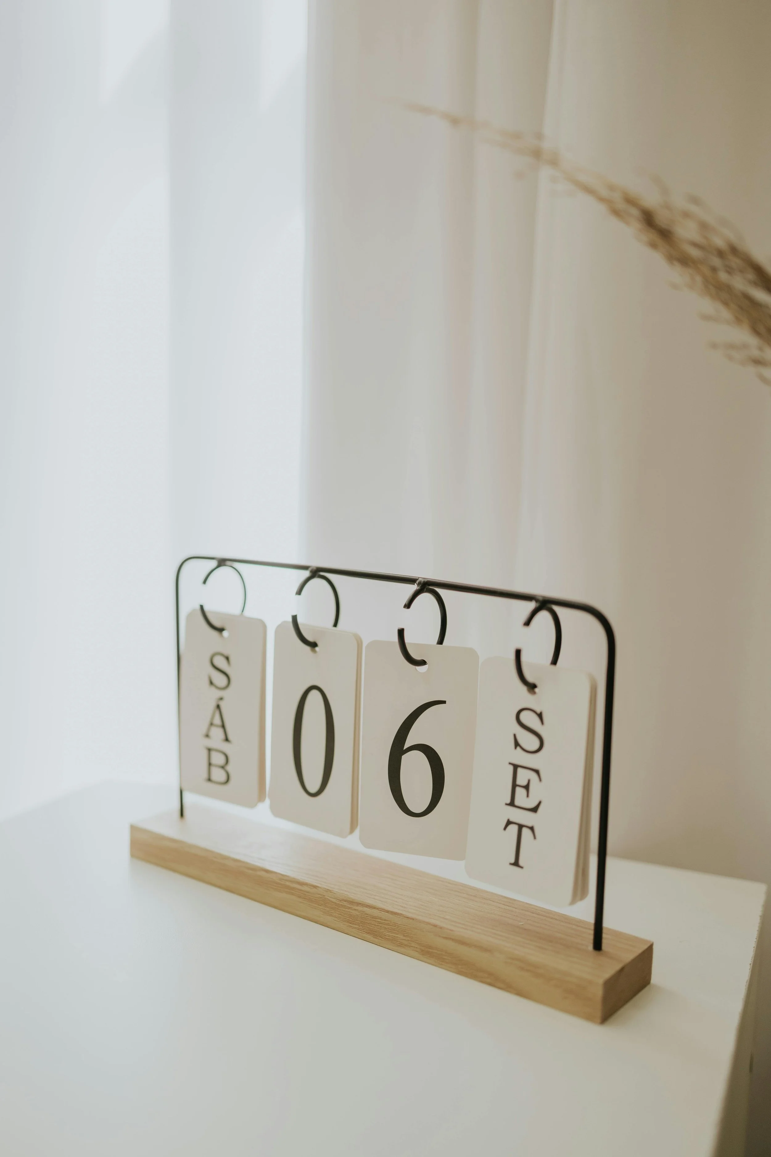 Calendar display stand arranged on a black metal frame with a wooden base.