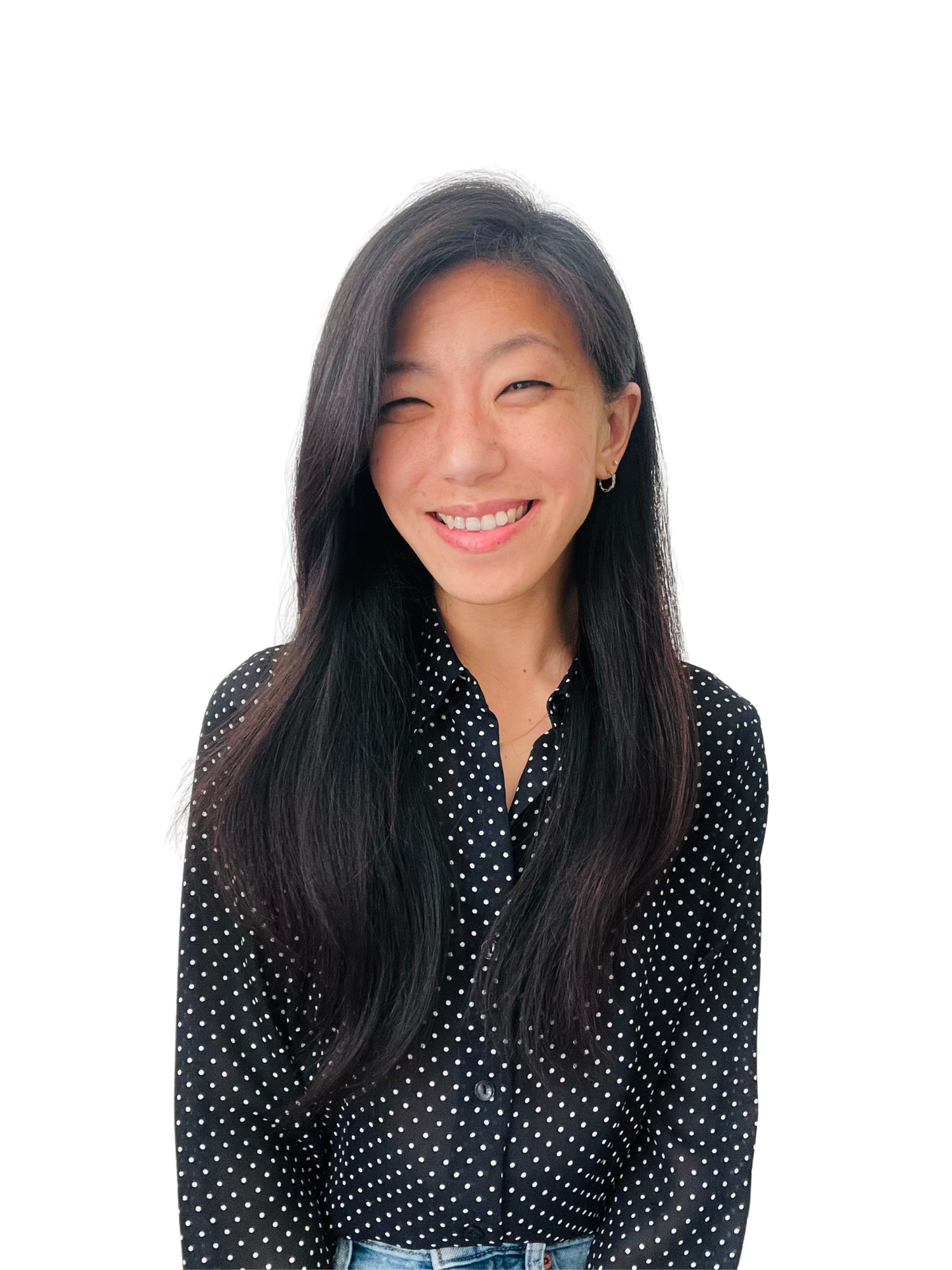 Clare Chi smiling, wearing a black and white polka dot shirt.
