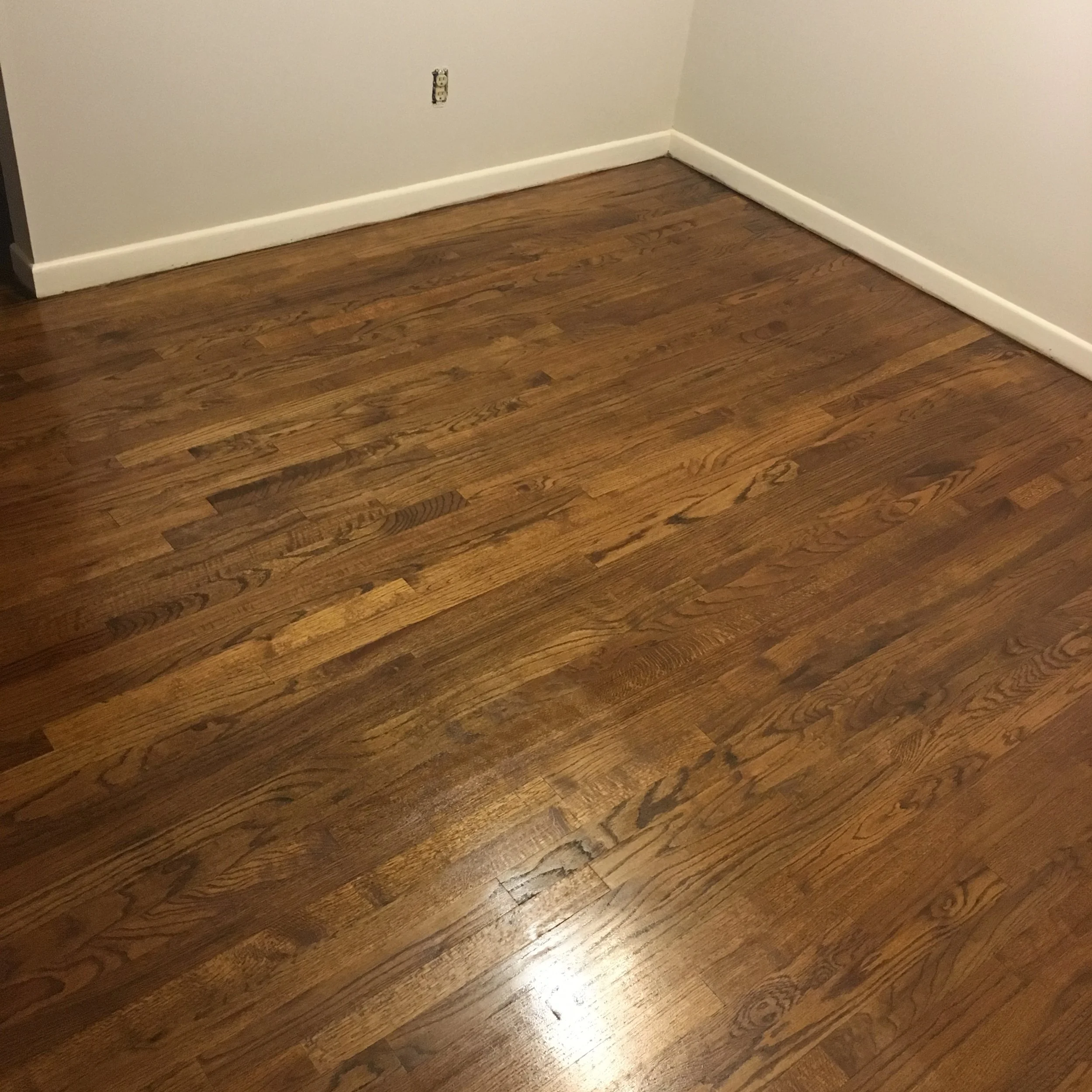 Finished the floor with a warm stain and multiple poly coats to keep it resilient for years.