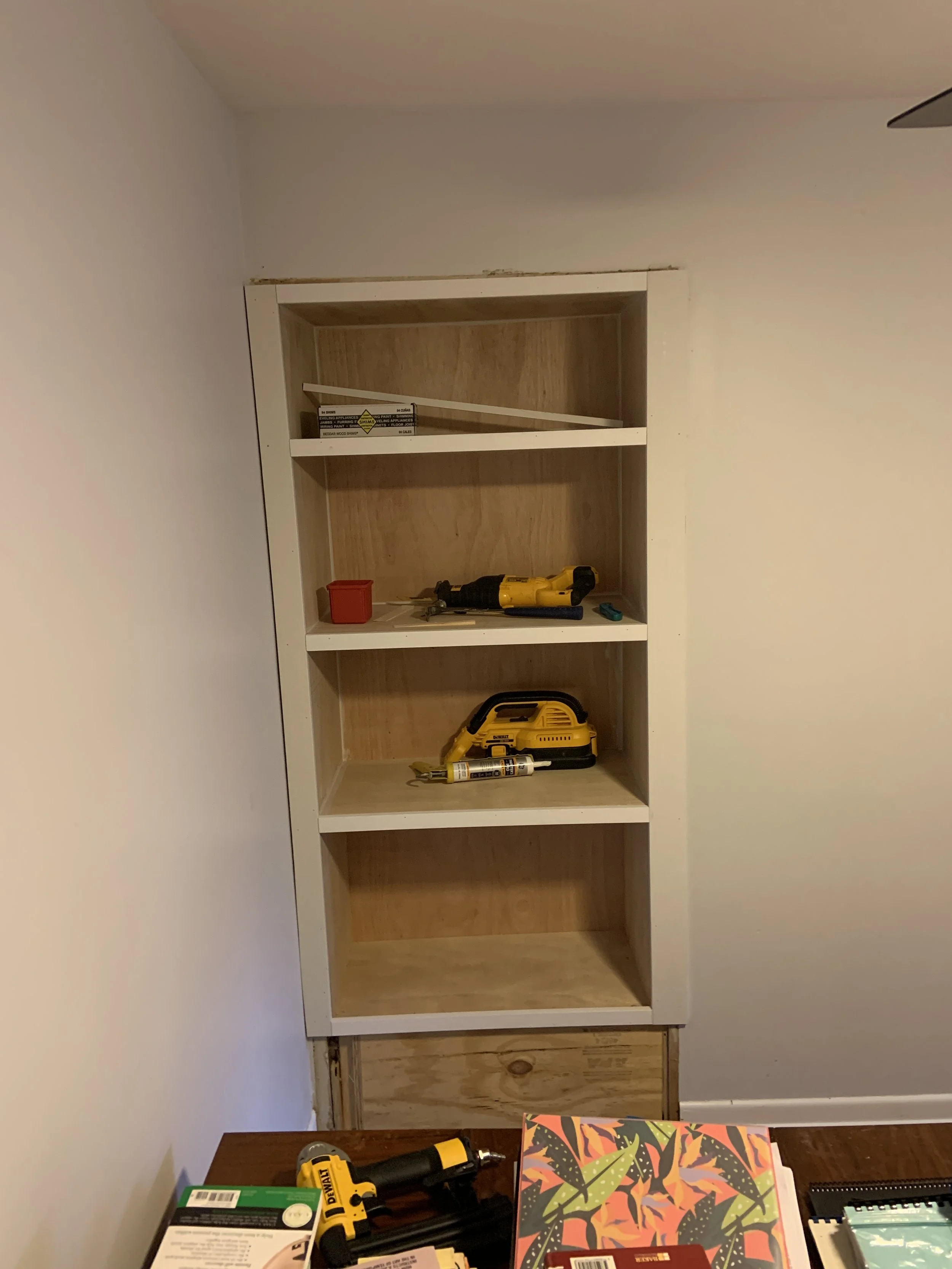 Took a shallow book shelf and made it functional with a built in shelves.