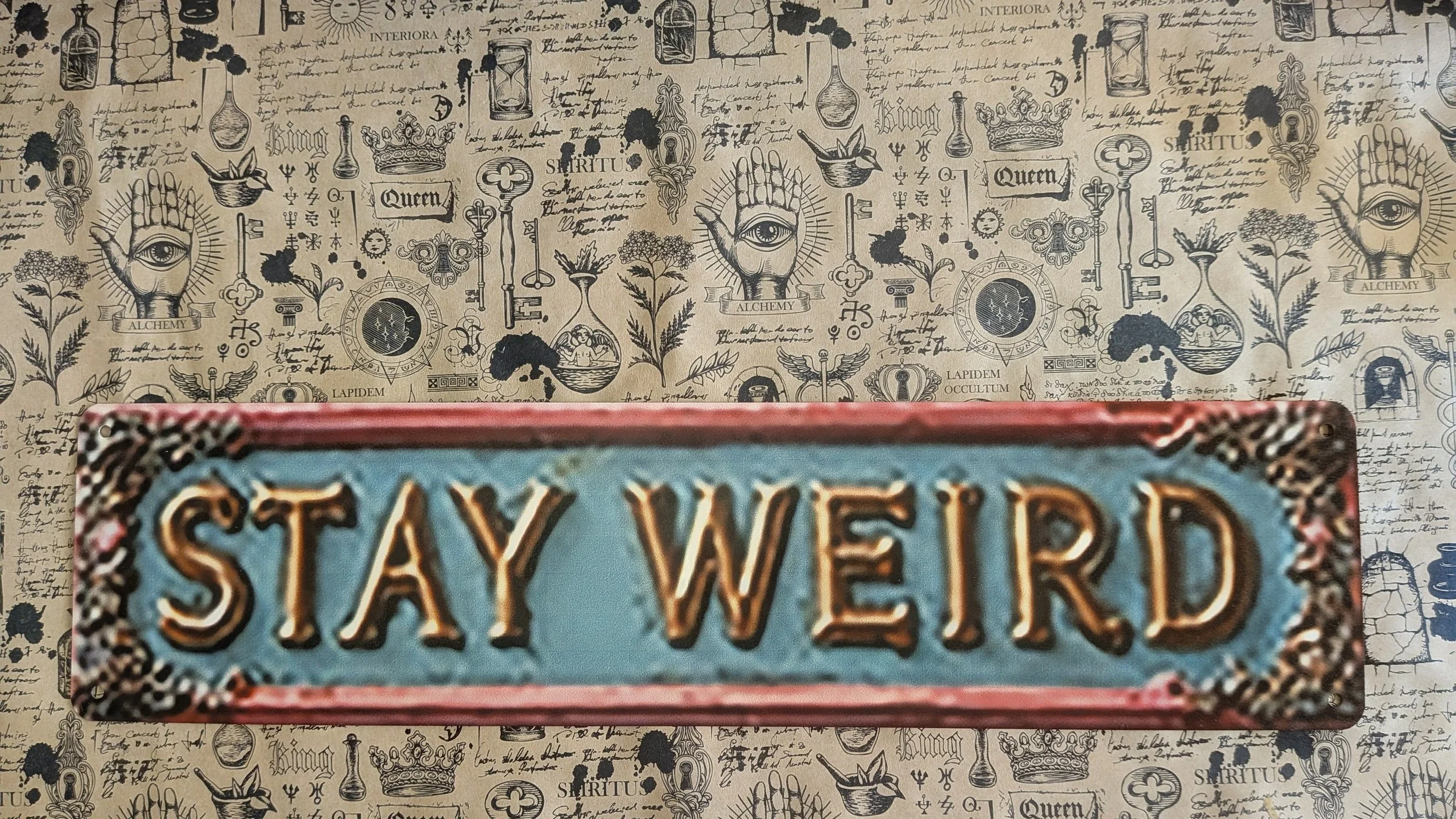 Tin 'Stay Weird ' sign