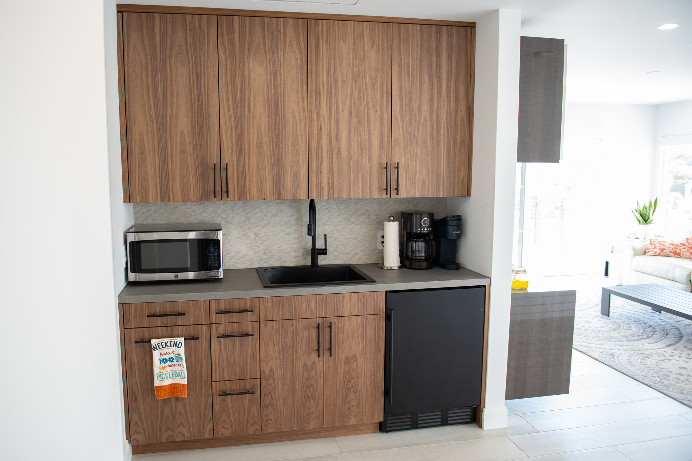 This is a coffee bar the clients wanted upstairs near the Primary Bedroom so they could wake to the smell of coffee! It features a full sink, trash pull outs, small fridge and soft close hardware.