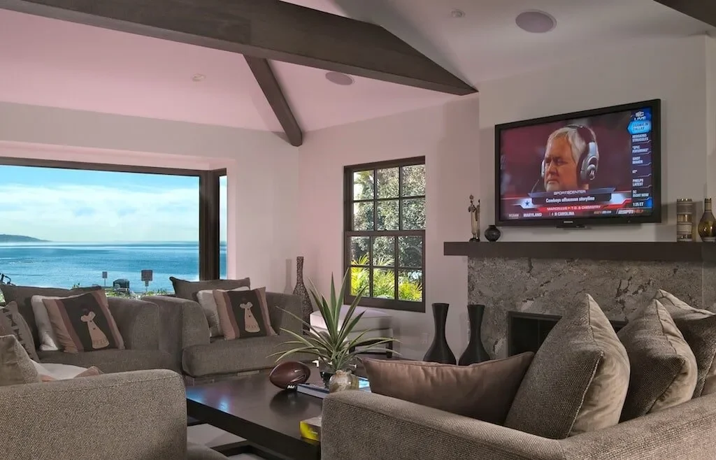 Beautiful home in La Jolla with flush mount speakers and a TV over the fireplace.  Full surround sound with no equipment showing.