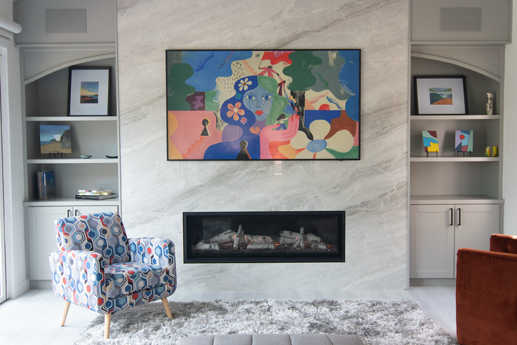 This remodeled house in Cardiff featured a dramatic slab and white cabinets housing a full surround sound with flush mount speakers.