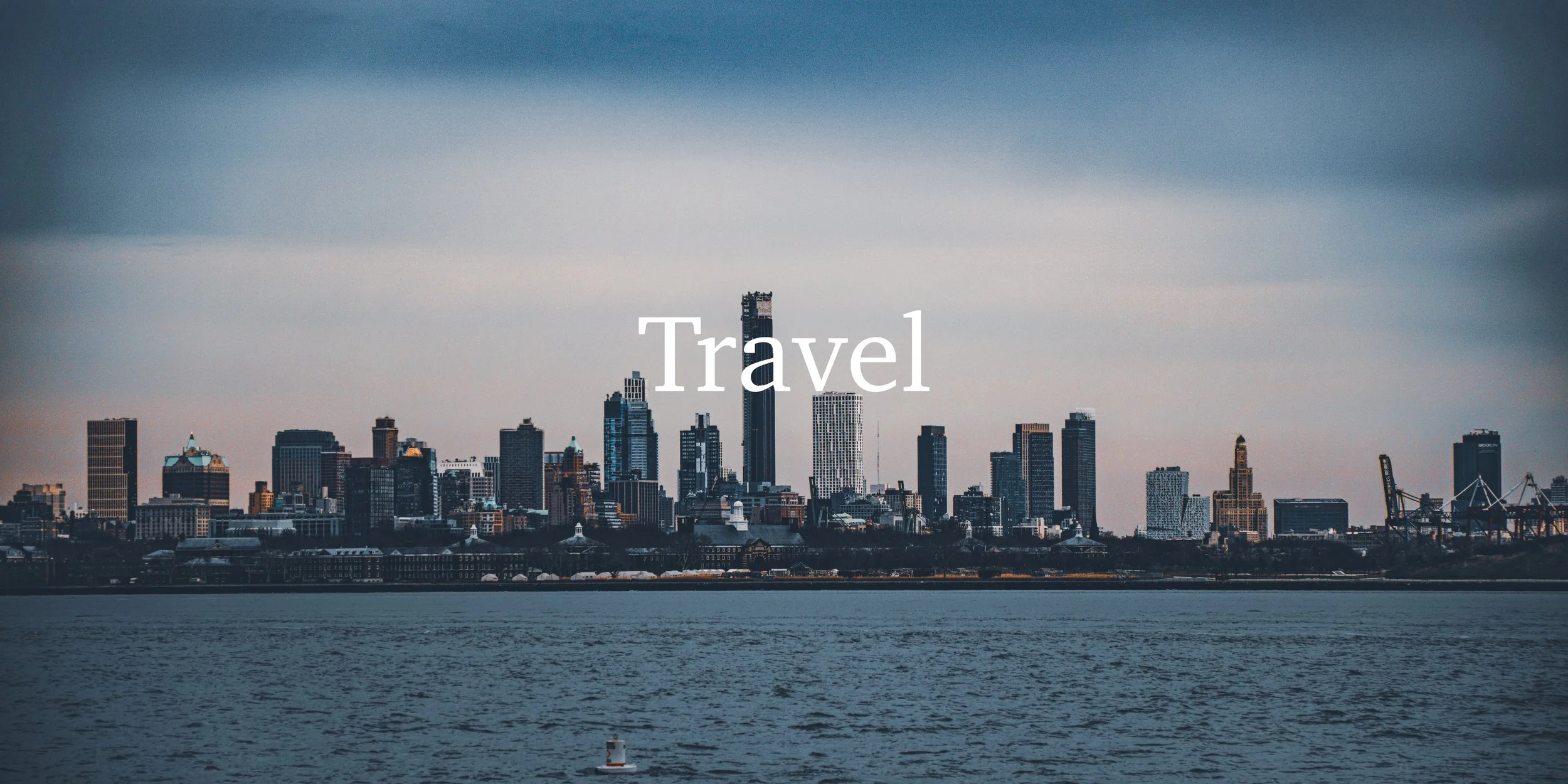 A city skyline with tall buildings viewed from across a body of water, overlaid with the word 'Travel'.