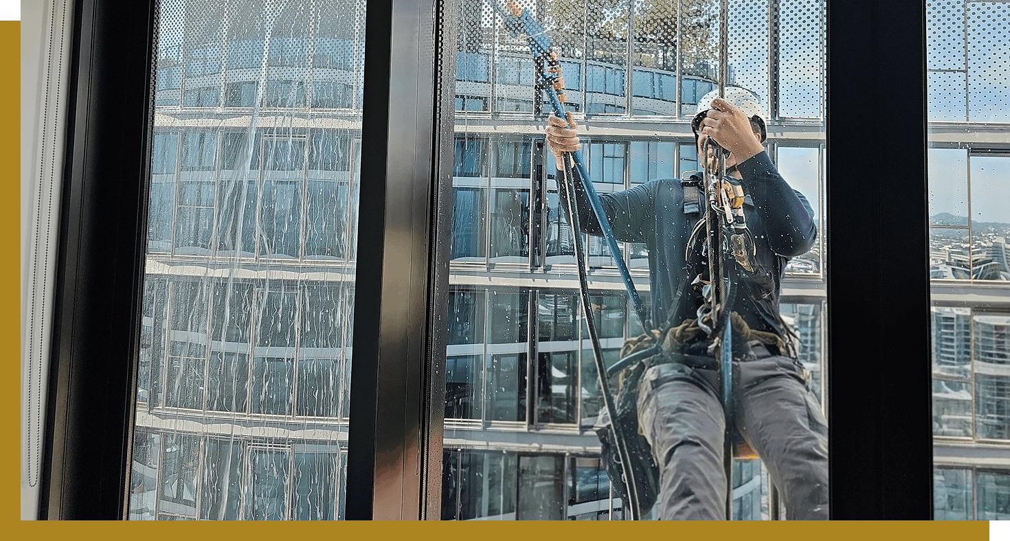 HD Glass glaziers performing leak detection and remediation on a high-rise building in Brisbane