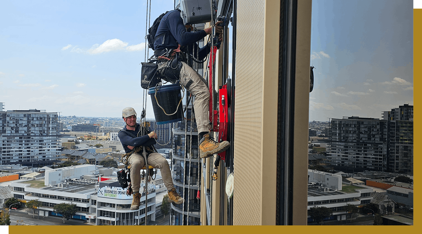 HD Glass glaziers working on a high-rise building in Brisbane with rope-access methods