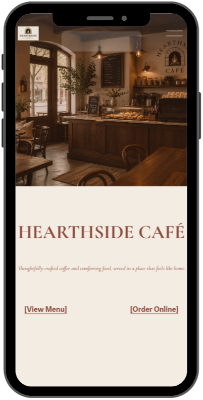 Interior of Hearthside Café with wooden tables, chairs, a glass display case, and warm lighting.