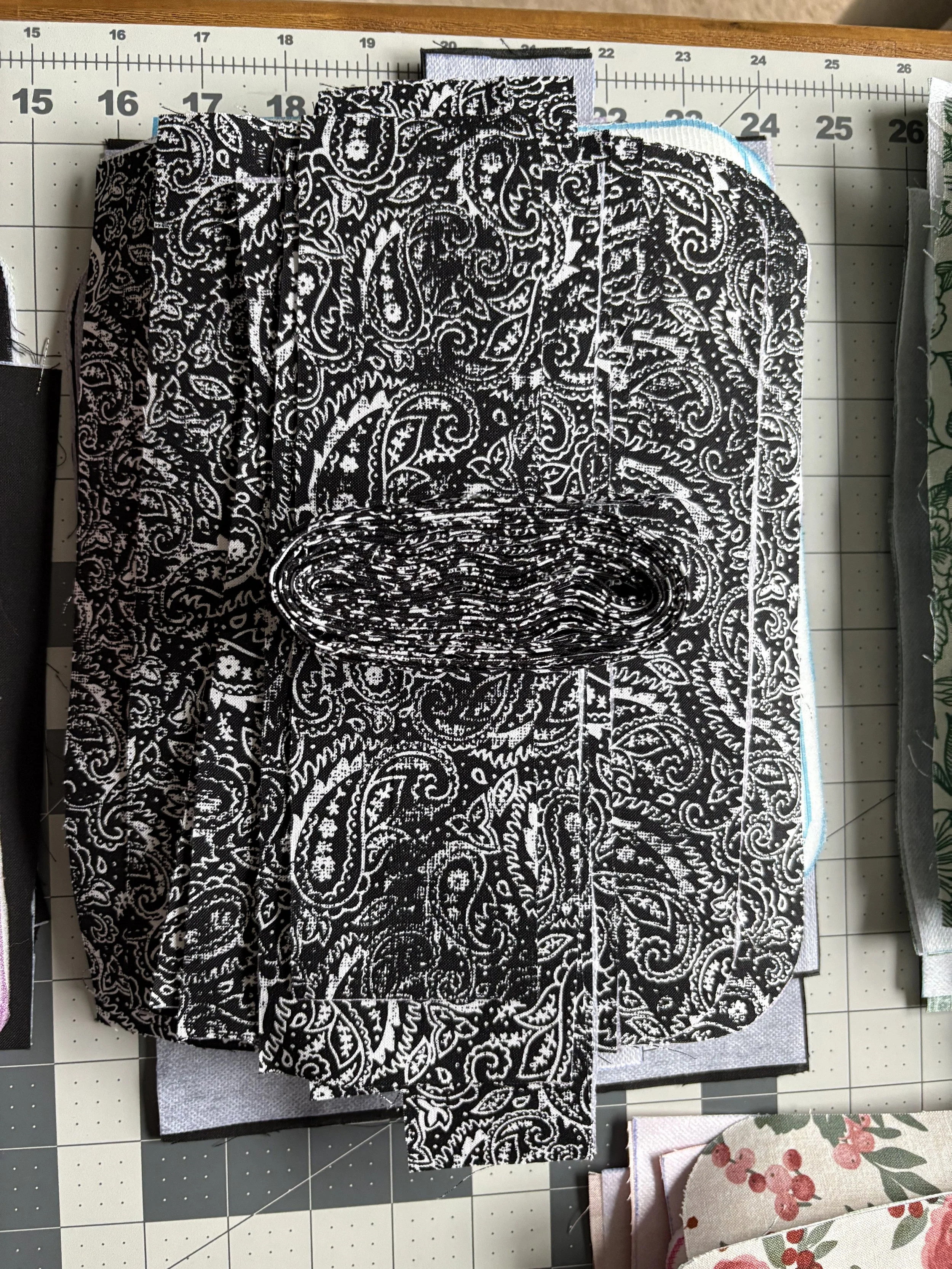 A single crossbody purse is constructed with 54 individually cut pieces, 3 zippers, 2 D-rings, 2 Swivel hooks, and a slide adjuster