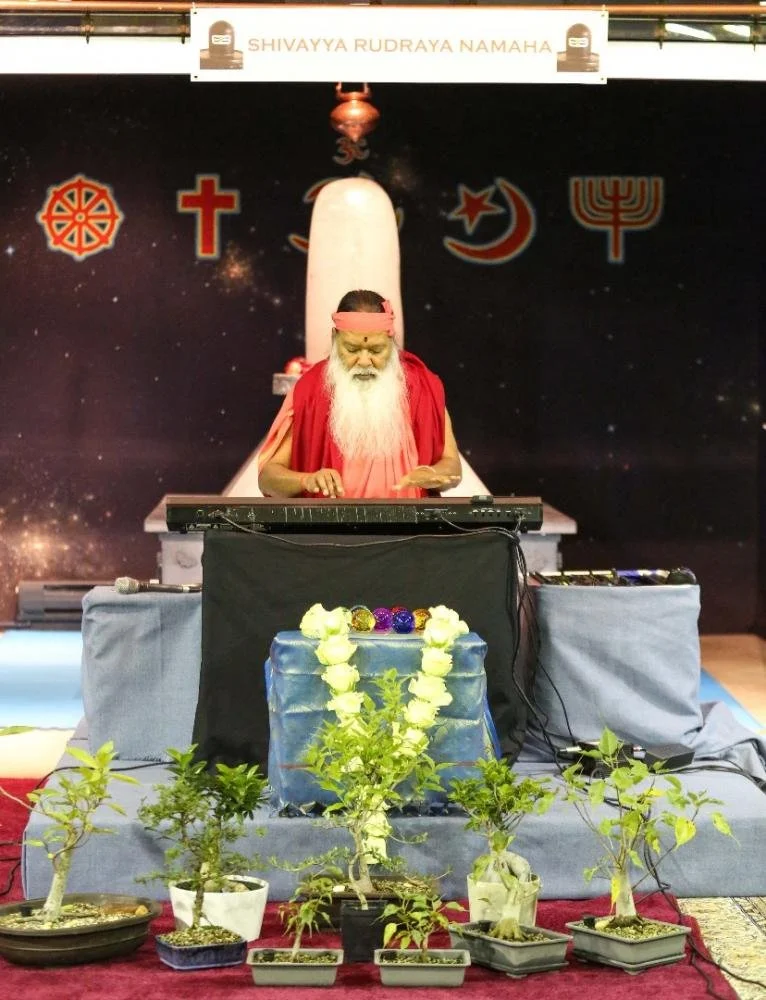 Sri Ganapathy Sachchidananda Swamiji playing the synthesizer.