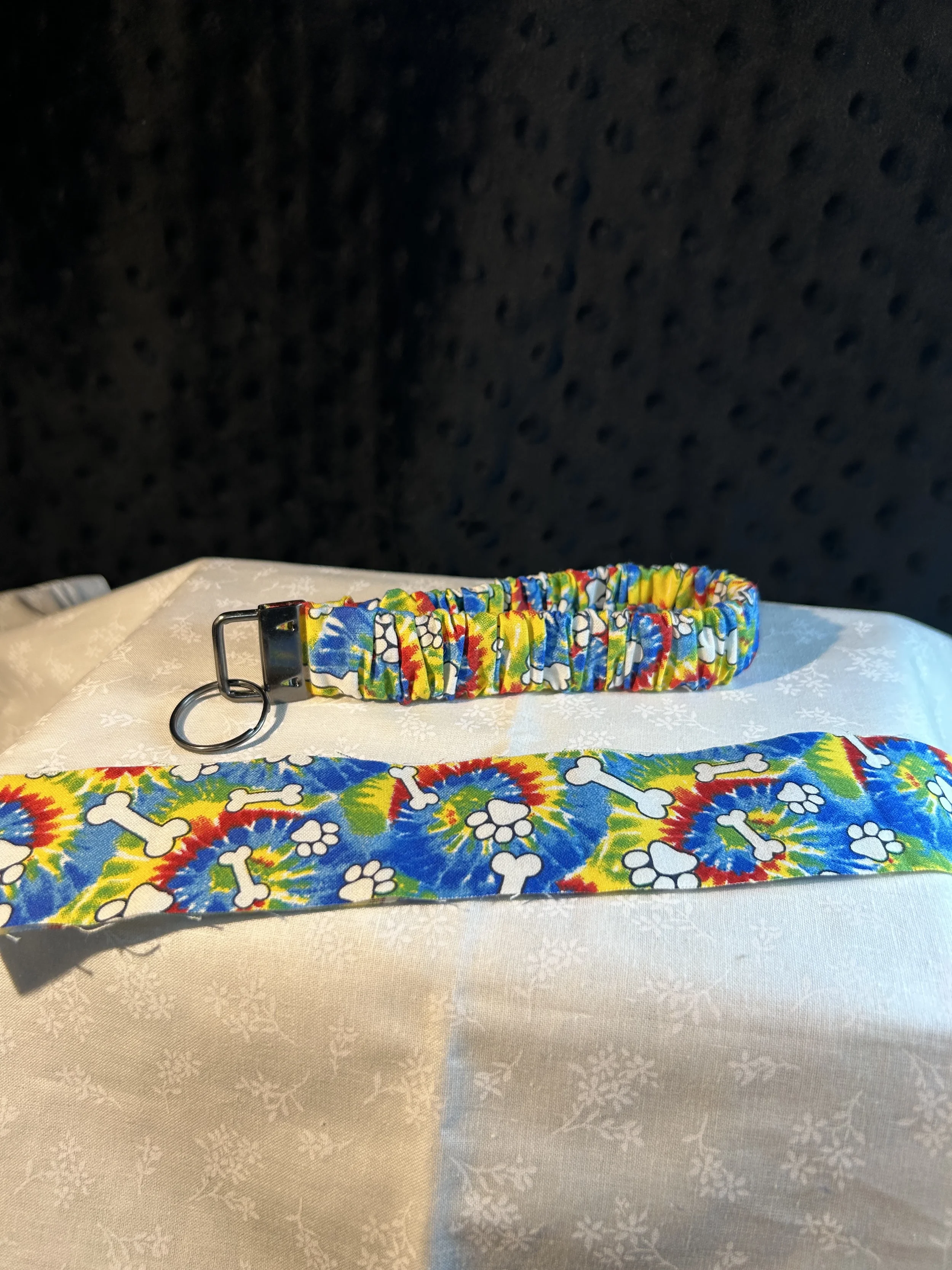 red/blu/yel dog bones/paws scrunchie keyfob.webp